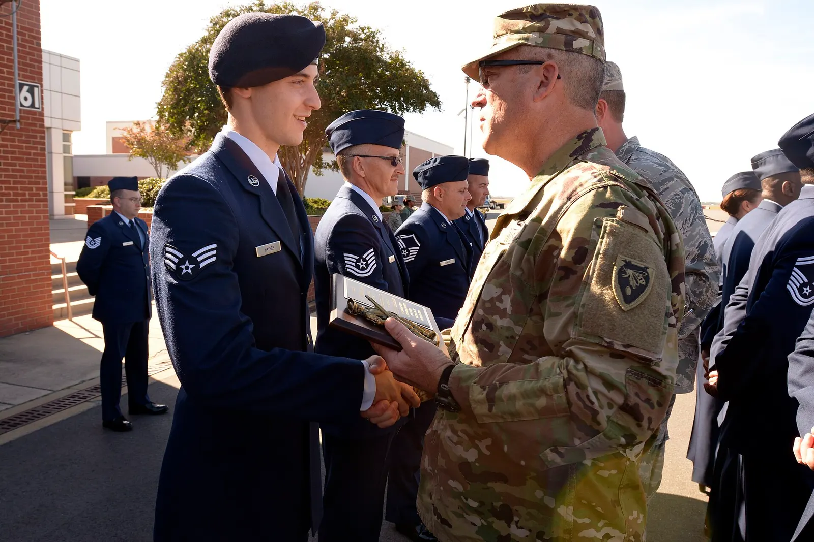 U.S. Army Maj. Gen. Greg Lusk (right), adjutant general of North Carolina, awards Airman 1st Class Dillion Haynes, 145th Security Forces Squadron, with Airman of the Quarter during a ramp formation held at the North Carolina Air National Guard Base, Charlotte Douglas International Airport, Nov. 6, 2