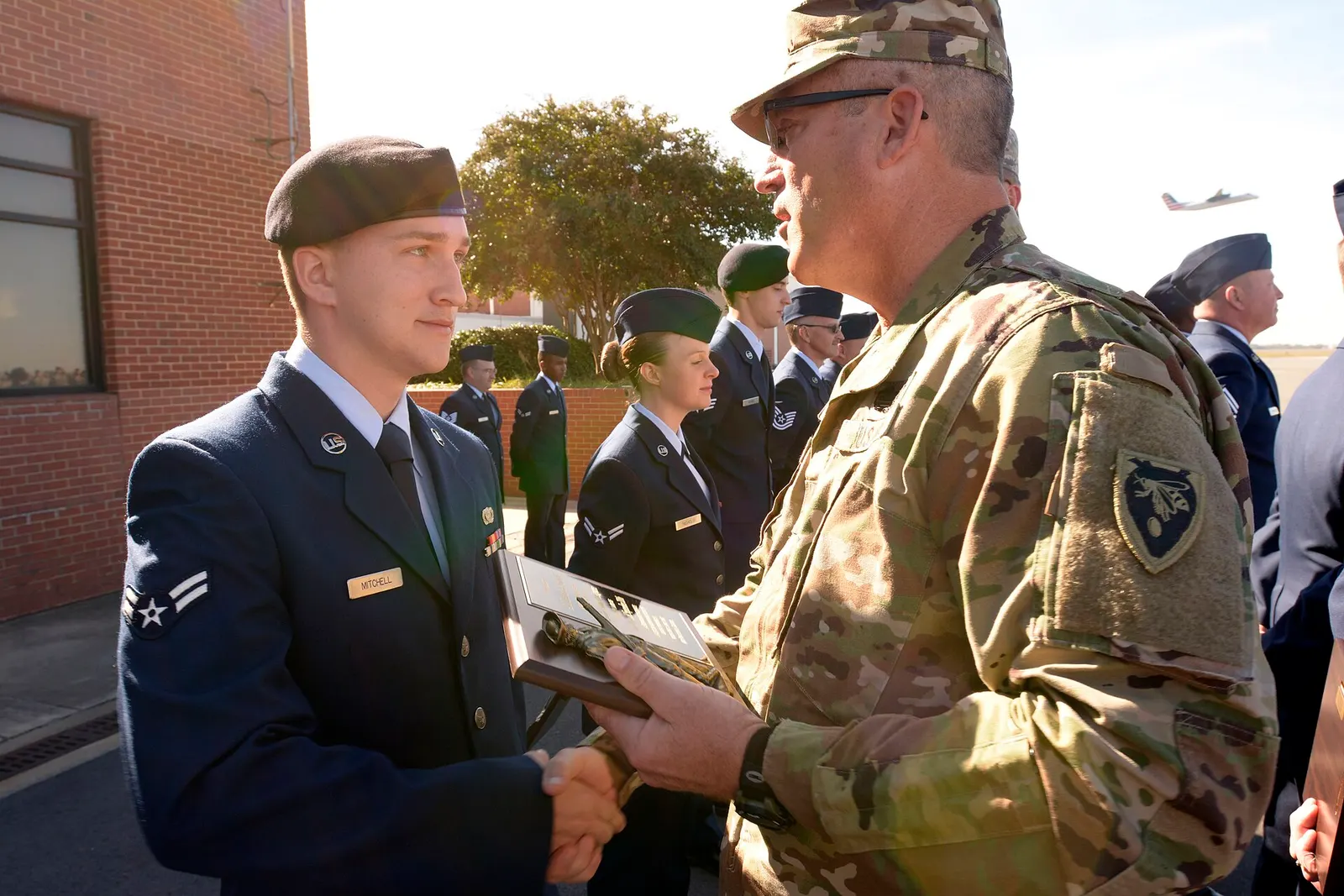 U.S. Army Maj. Gen. Greg Lusk (right), adjutant general of North Carolina, awards Airman 1st Class Zachary Mitchell, 145th Security Forces Squadron, with Airman of the Quarter during a ramp formation held at the North Carolina Air National Guard Base, Charlotte Douglas International Airport, Nov. 6,
