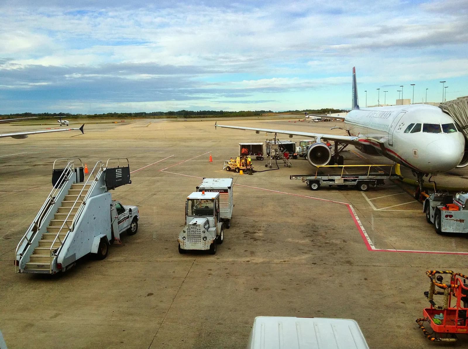A wide exterior panorama of Charlotte Douglas International Airport showing terminal buildings, parking areas, and the airfield.