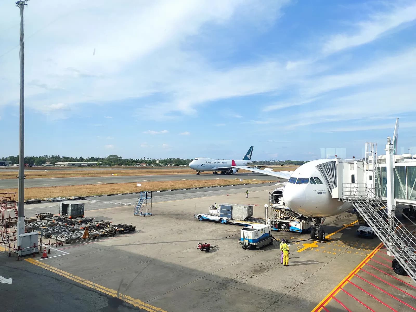 SriLankan Airlines Airbus A330 at a CMB gate with Cathay Pacific Cargo on the taxiway