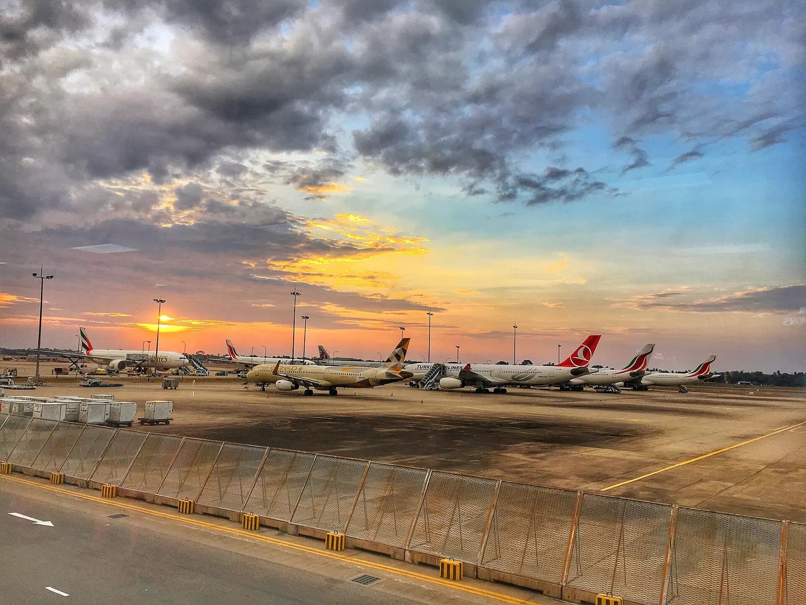 Sunset apron view at Bandaranaike International Airport with SriLankan, Emirates, Etihad and Turkish aircraft