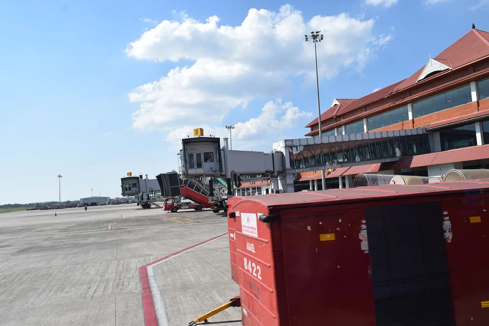 Cochin International Airport apron jet bridges and Kerala-style red-tiled terminal roof