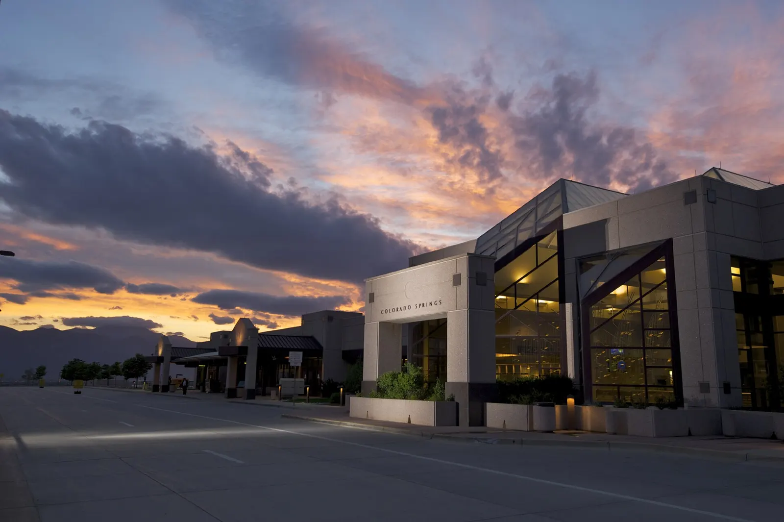 Dusk view of the Colorado Springs Airport passenger terminal facade and roadway, photographed in 2009.