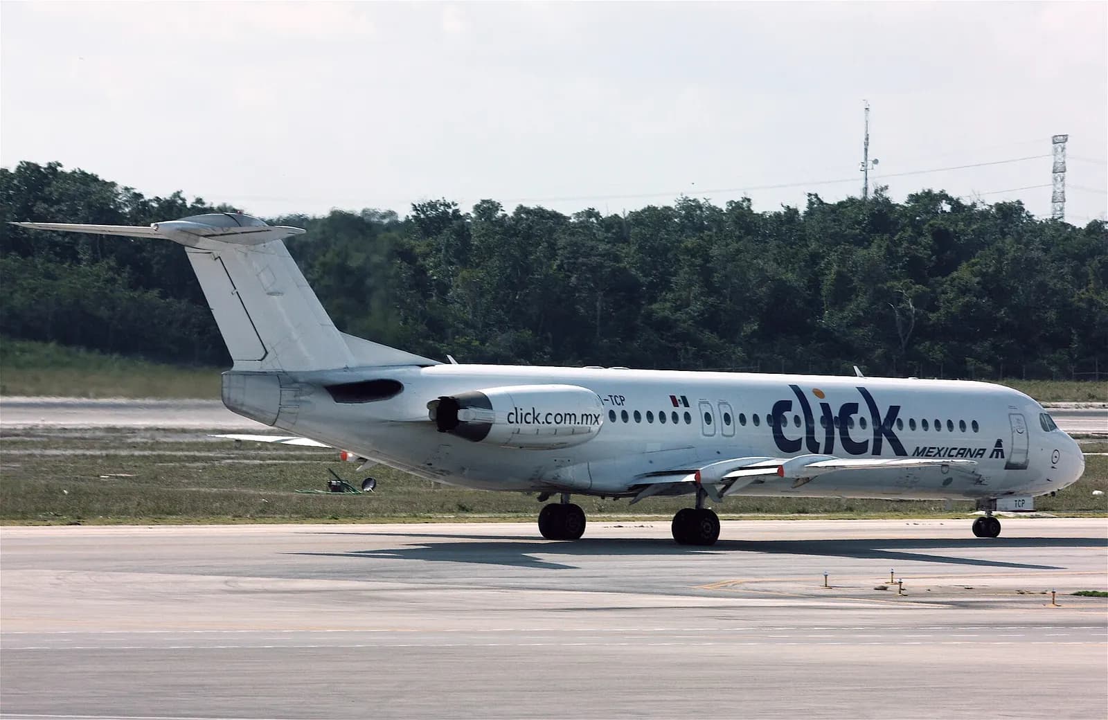 Mexicana Click Fokker 100 at Cancun International Airport.