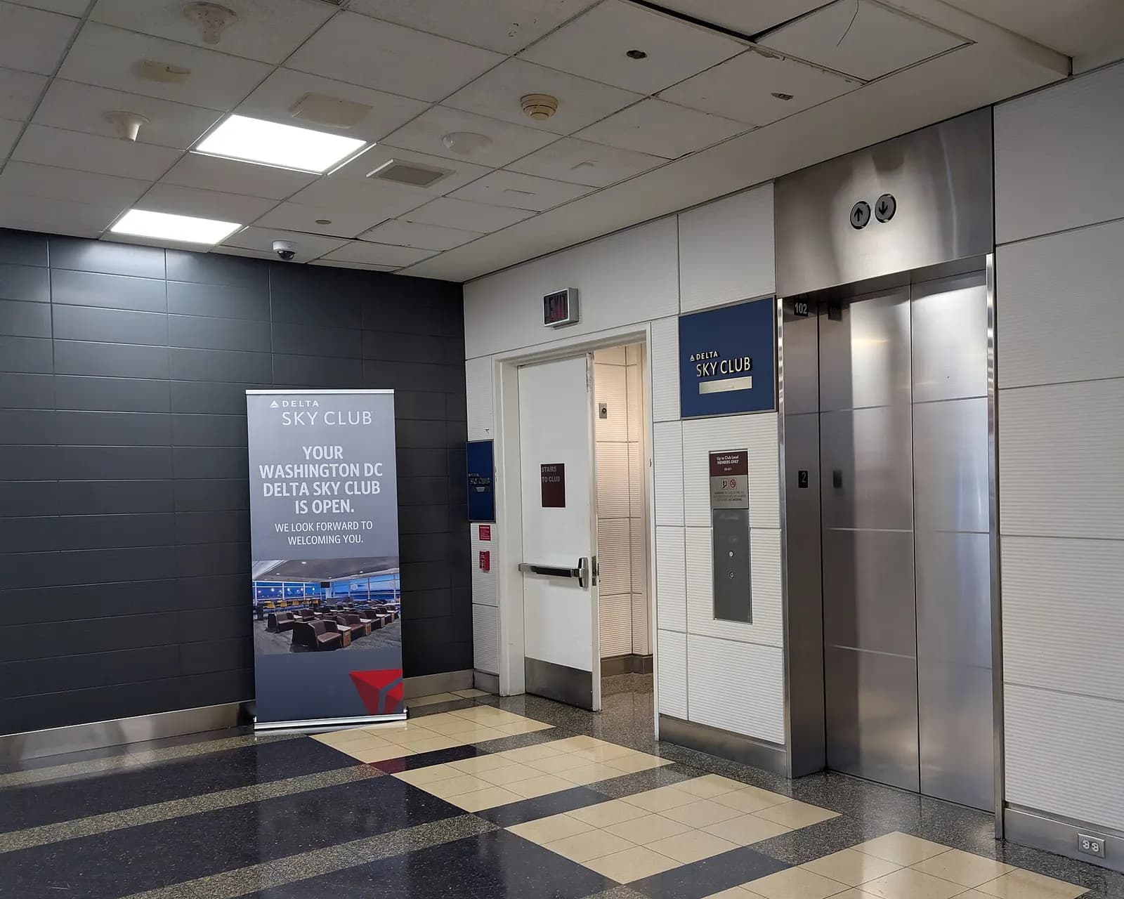 The entrance to the Delta Sky Club at Concourse B near gate 15. The club is up one level and there are stairs and an elevator up to it. Terminal 2, Washington National Airport, Arlington, Virginia 22201.