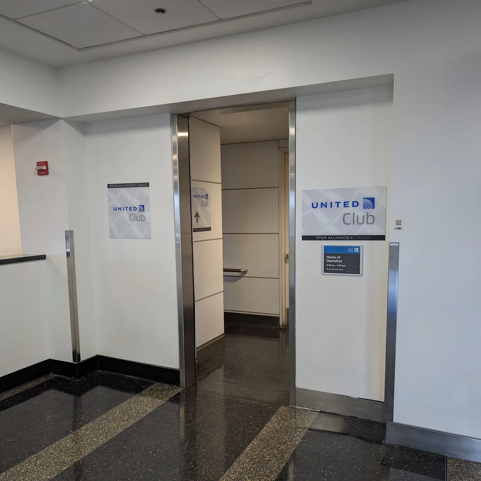 The entrance to the United Airlines United Club at Concourse B, opposite gate B11. The club is up one level and the stairs are just inside the entrance on the left. Terminal 2, Washington National Airport, Arlington, Virginia 22201.