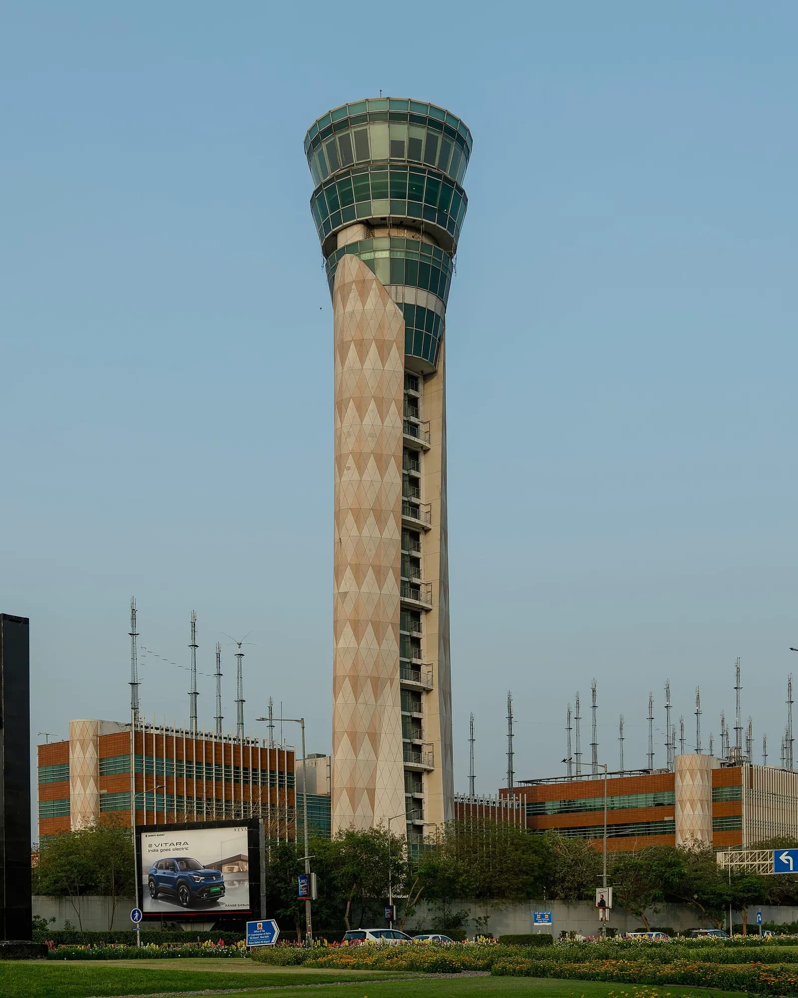 The tall, flared air traffic control tower rising above the terminal buildings at Indira Gandhi International Airport in New Delhi.