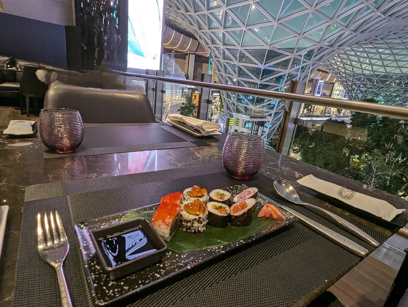 Fresh sushi prepared to order at a counter in the Al Mourjan Garden Lounge at Hamad International Airport.