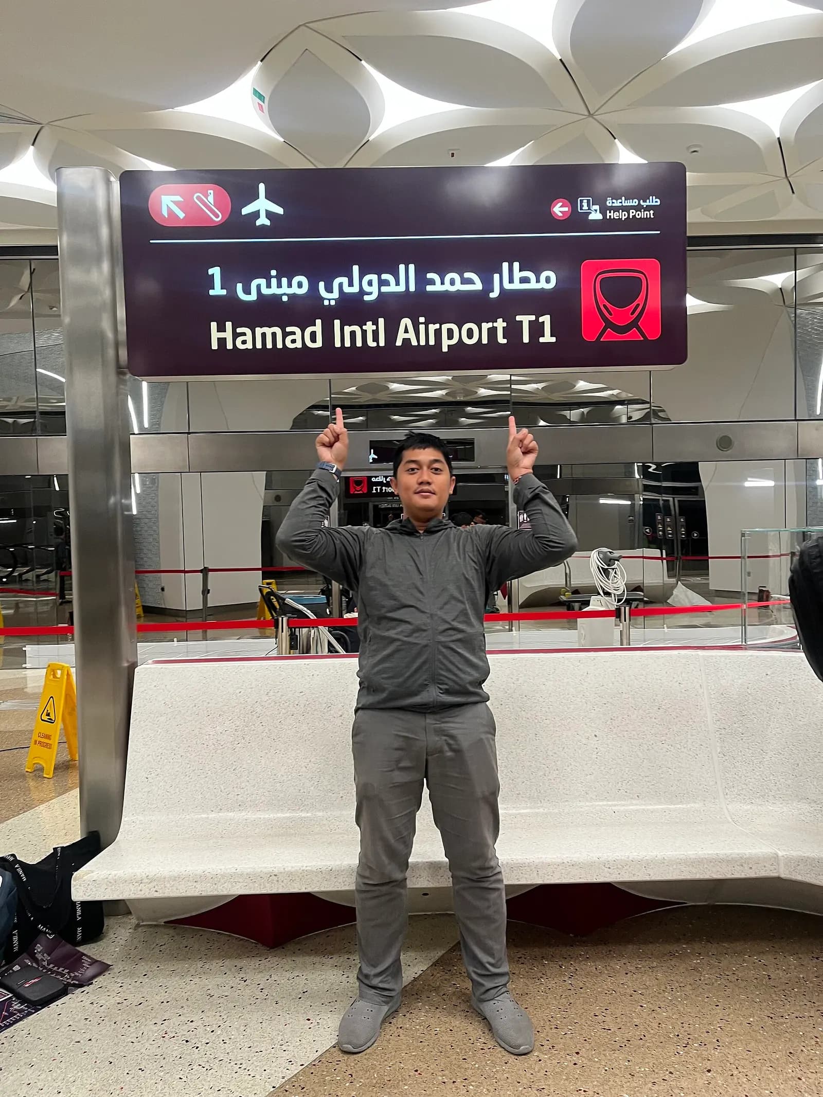 The Hamad International Airport metro train station platform with signage for the rail link to central Doha.