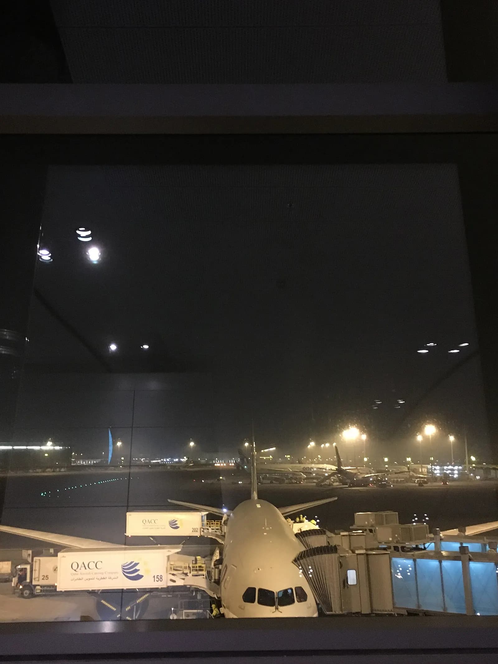The bright, spacious main concourse inside Hamad International Airport with high ceilings and sleek modern architecture.