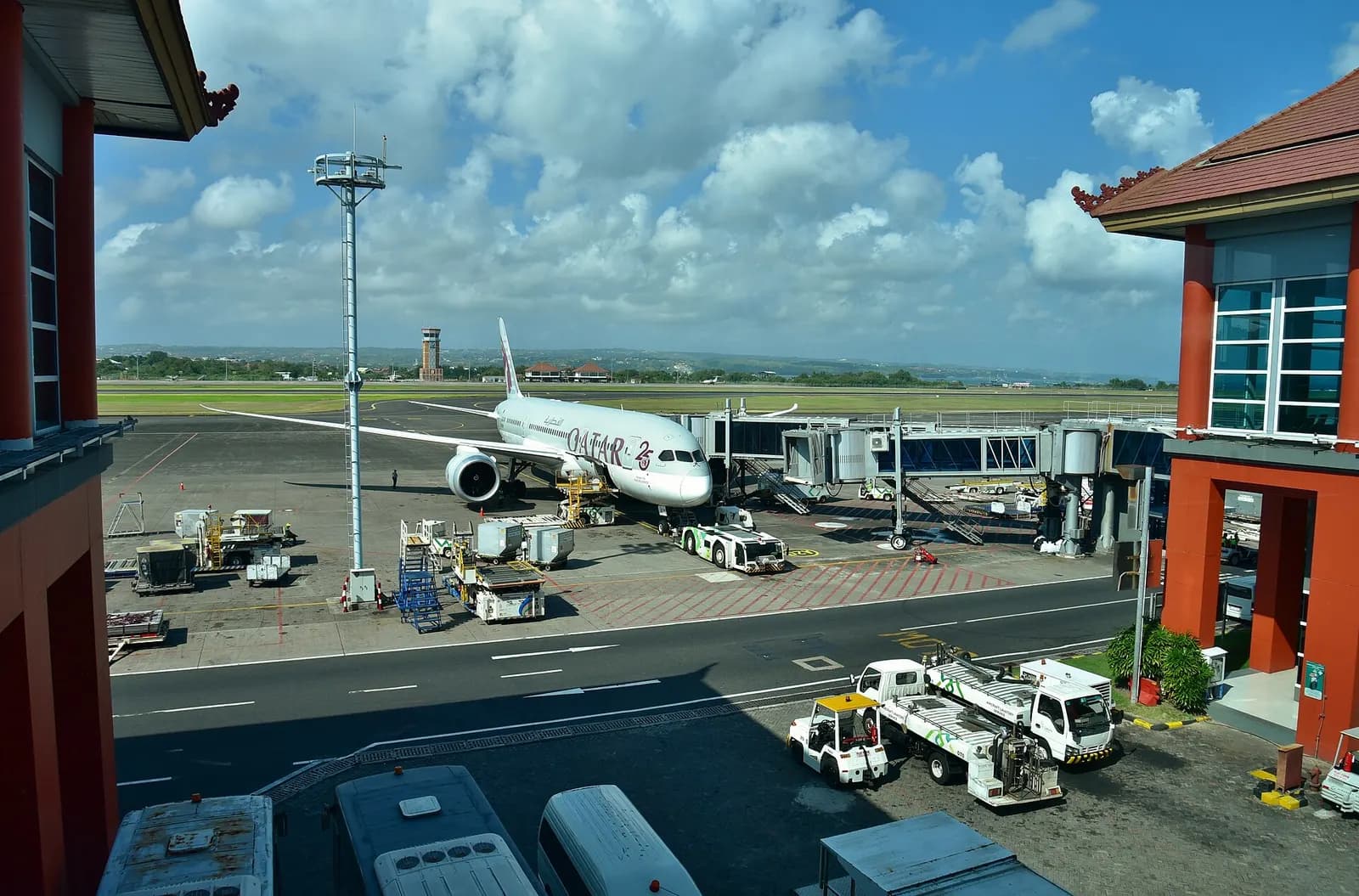 Qatar Airways Boeing 787-8 A7-BCW pausing at the International Terminal at Ngurah Rai International Airport (DPS/WADD), Denpasar, Bali, Indonesia, between arriving from Doha (DOH/OTHH) as QR964 and departing for the same airport as QR965. Photo taken from the International Terminal.