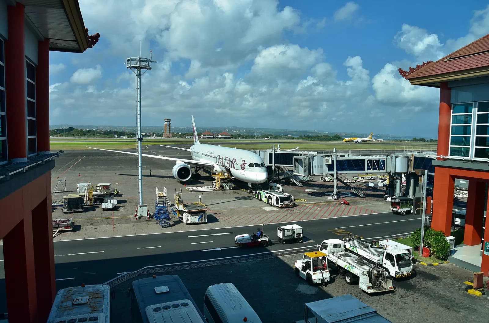 Qatar Airways Boeing 787-8 A7-BCW pausing at the International Terminal at Ngurah Rai International Airport (DPS/WADD), Denpasar, Bali, Indonesia, between arriving from Doha (DOH/OTHH) as QR964 and departing for the same airport as QR965. Photo taken from the International Terminal.