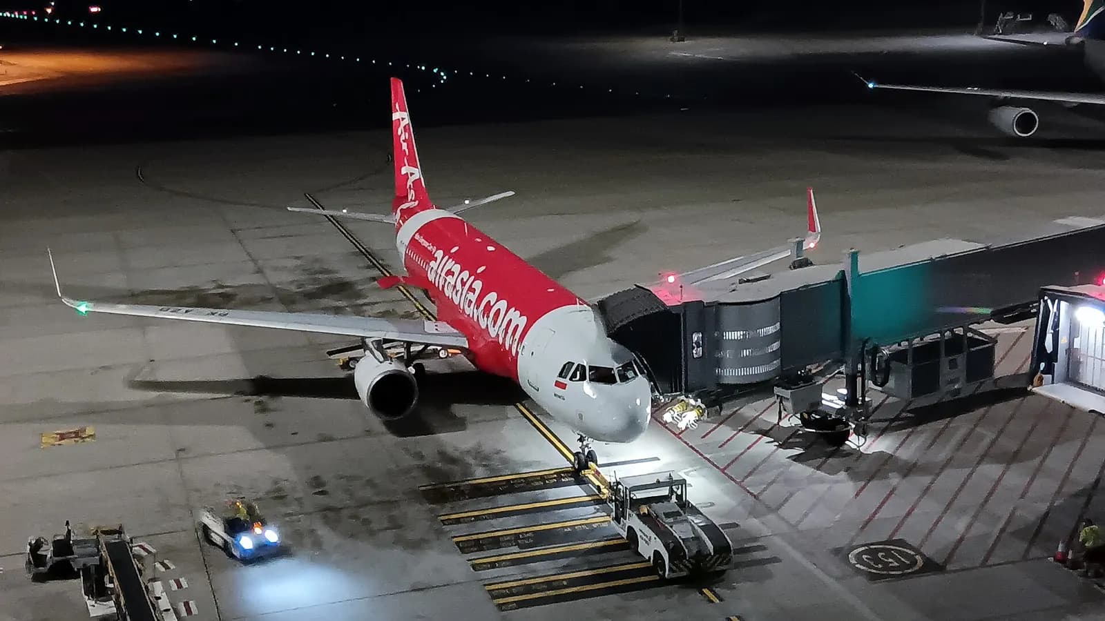 Indonesia AirAsia Airbus A320-214 PK-AZX pauses at Terminal 1, Perth Airport (PER/YPPH), Western Australia, between arriving from Ngurah Rai International Airport (DPS/WADD) as QZ536 and departing for the same airport as QZ537