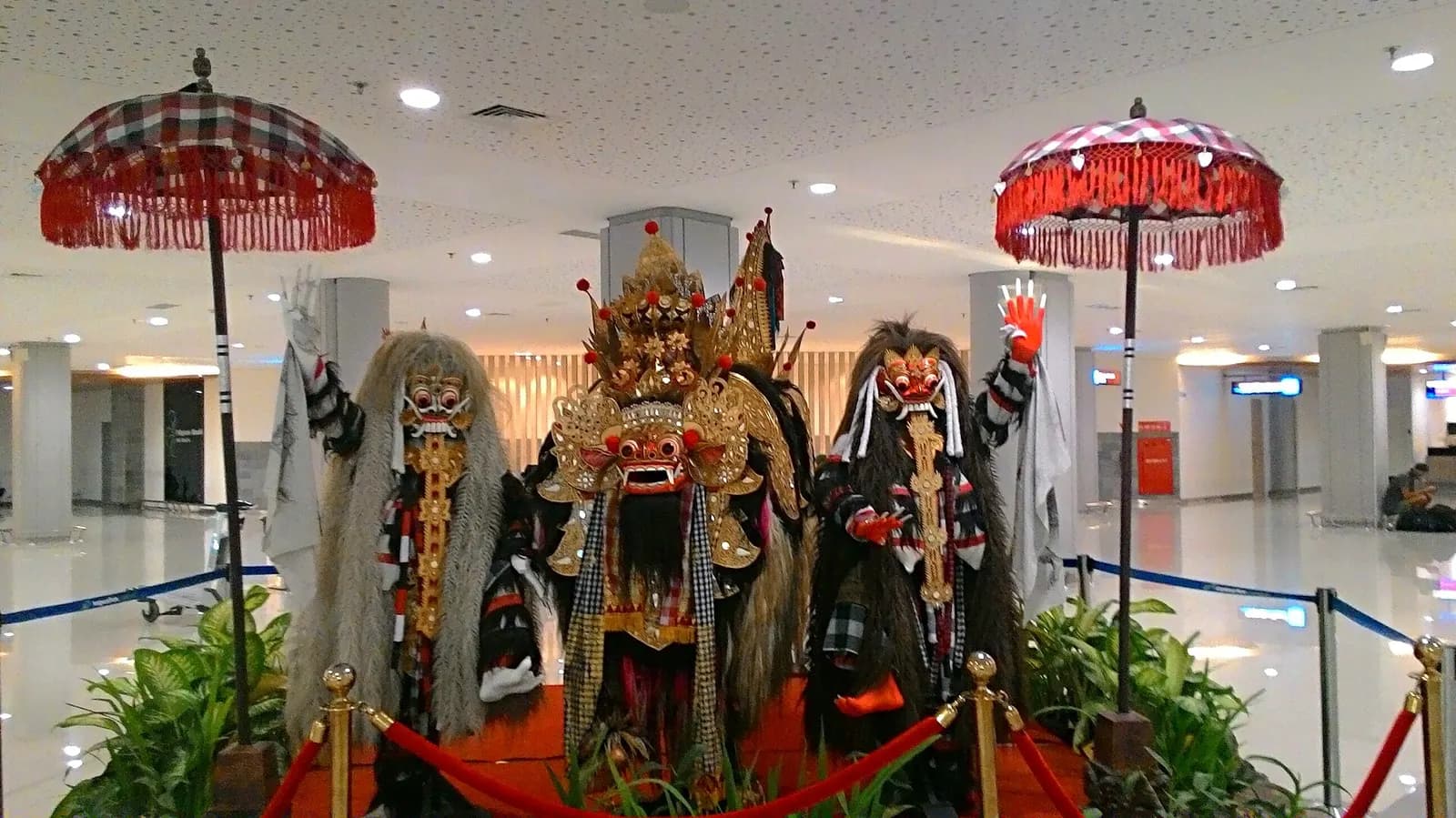 A Barong between two Rangdas displayed at Arrival Terminal, I Gusti Ngurah Rai International Airport, Bali