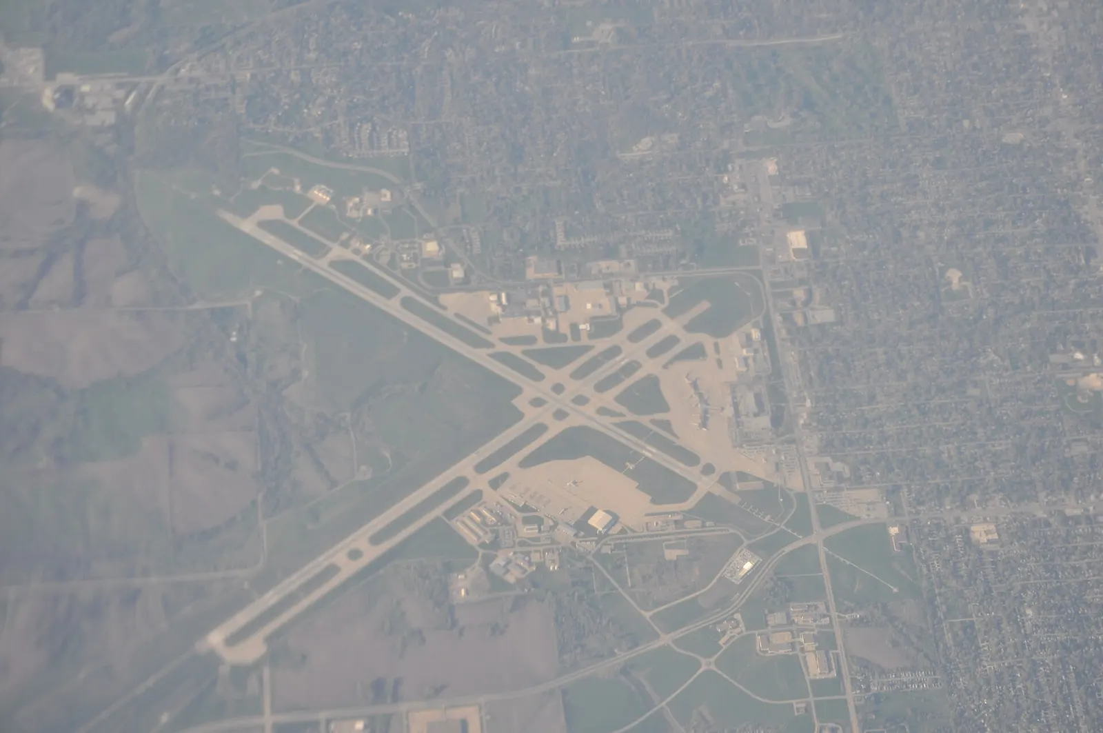 April 2012 aerial of Des Moines International Airport looking across the civil terminal and runways.
