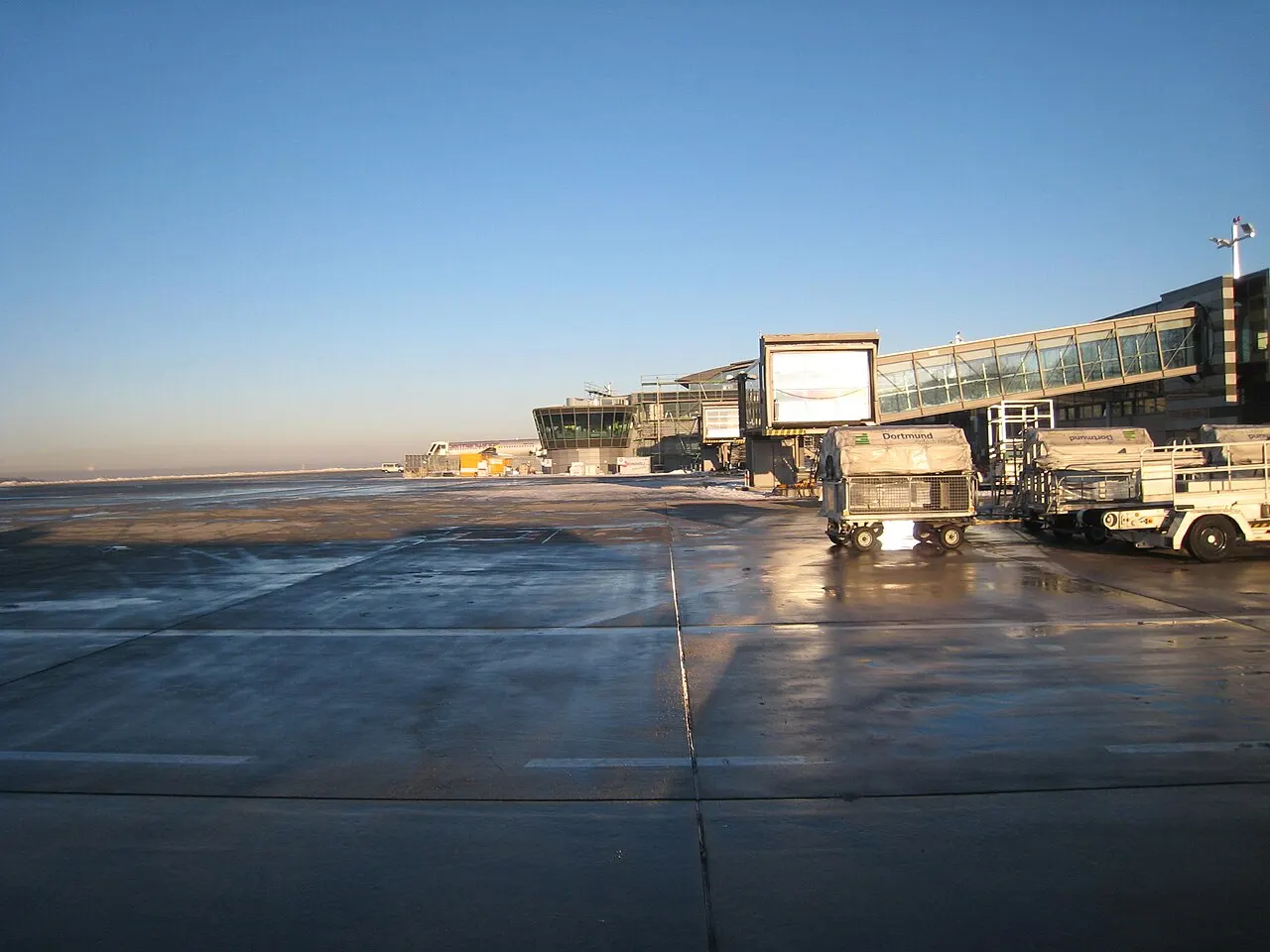 Dortmund Airport apron and terminal with Dortmund-branded baggage carts (2009)