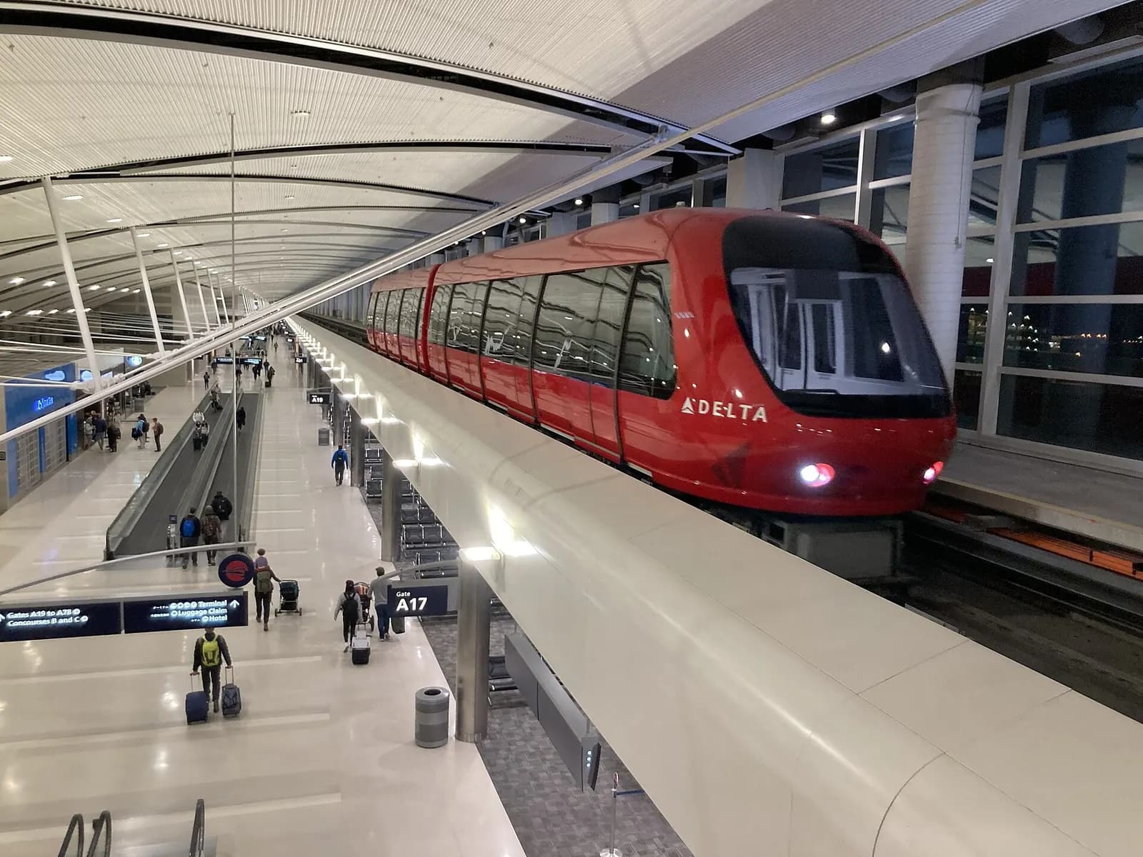 The red-and-white ExpressTram pulls into a station inside Concourse A of the McNamara Terminal at Detroit Metropolitan Airport.