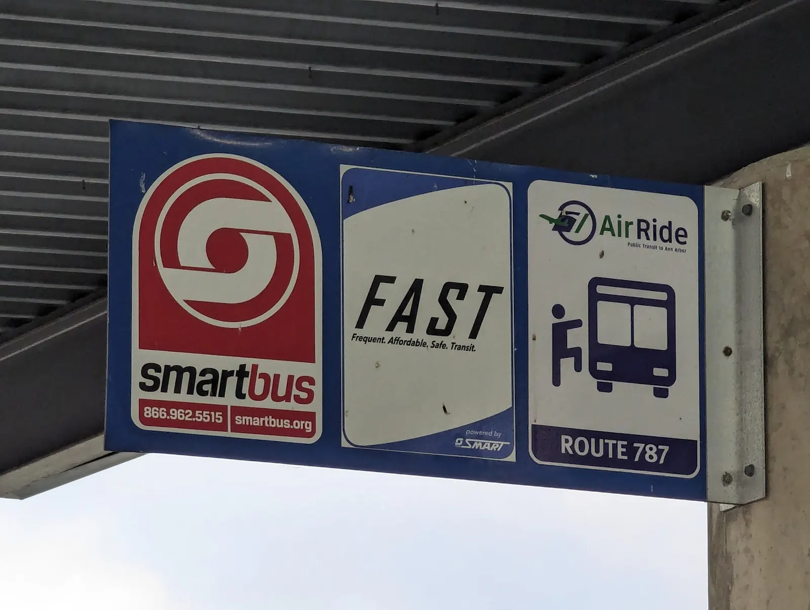 A directional sign listing bus and ground-transportation options at the Evans Terminal ground transportation center at Detroit Metropolitan Airport.