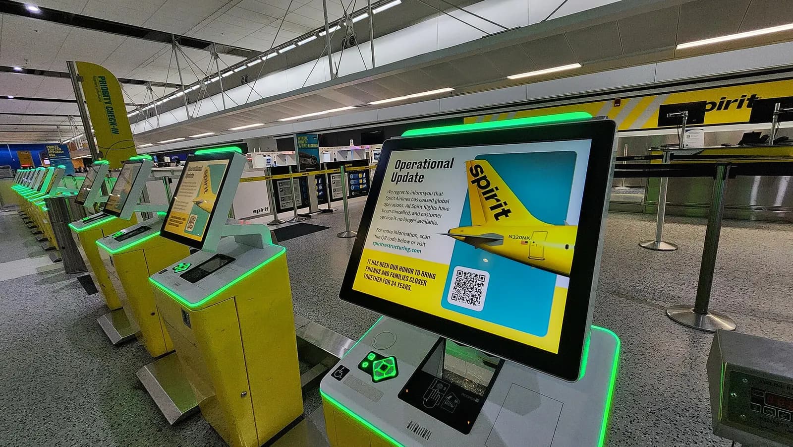 Check-in kiosks, displaying a message that Spirit Airlines has ceased operations, at the disused Spirit check-in counter in the Evans Terminal at Detroit Metropolitan Wayne County Airport, four days after Spirit ended operations.