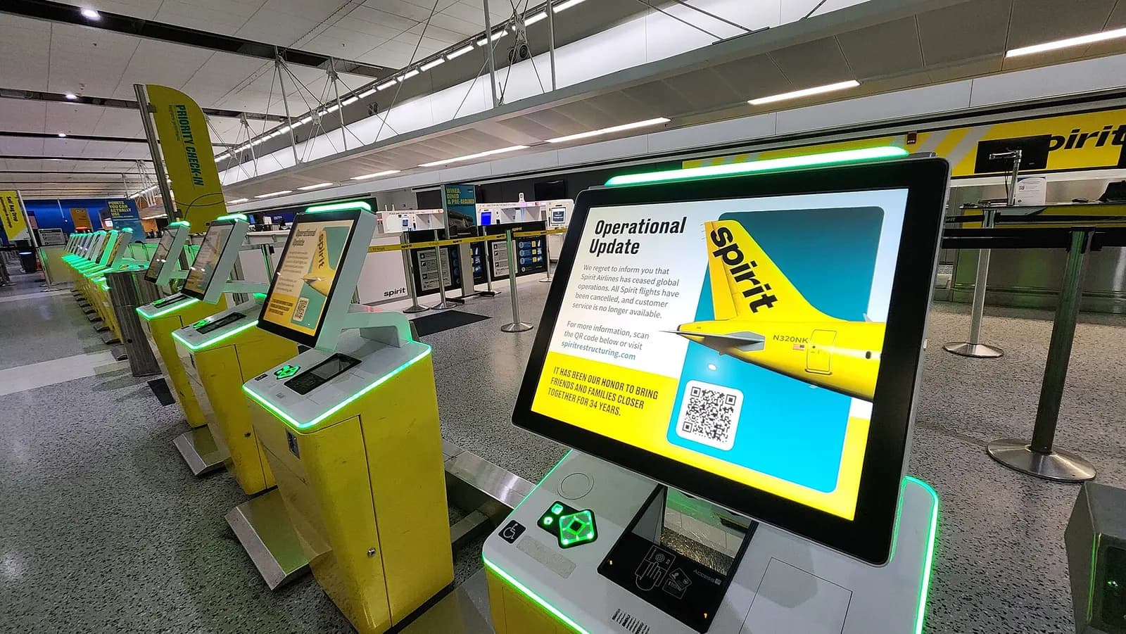 Check-in kiosks, displaying a message that Spirit Airlines has ceased operations, at the disused Spirit check-in counter in the Evans Terminal at Detroit Metropolitan Wayne County Airport, four days after Spirit ended operations.