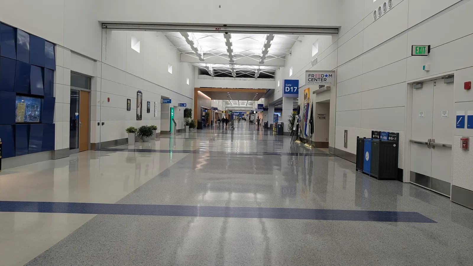 The bright, modern interior of the Evans Terminal at Detroit Metropolitan Airport with check-in counters and a relatively quiet departures hall.