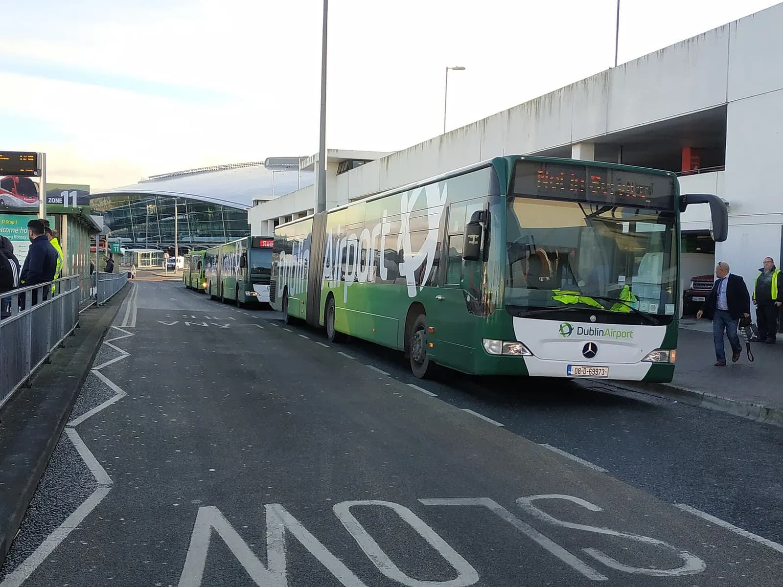 A long Mercedes-Benz Citaro articulated shuttle bus branded for Dublin Airport, used to move passengers between car parks and terminals.