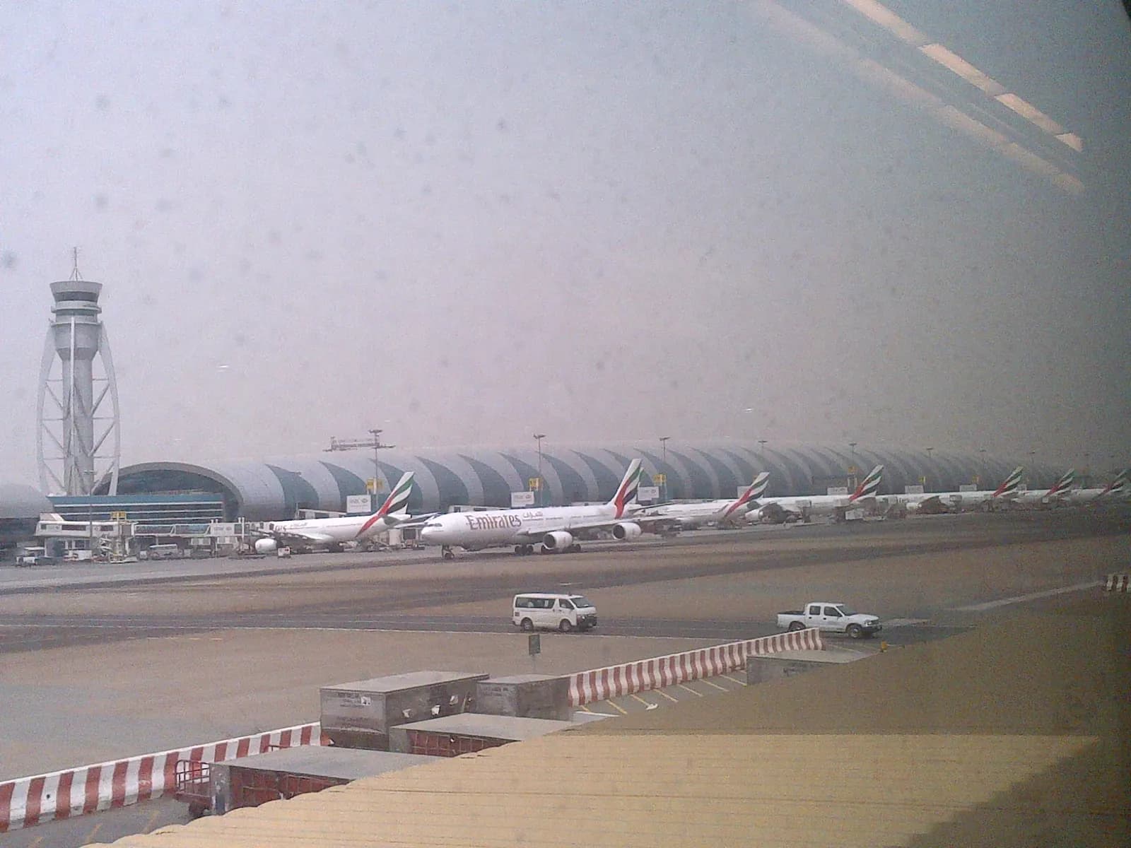 The curved Terminal 3 building seen across the airfield from the Terminal 1 complex.