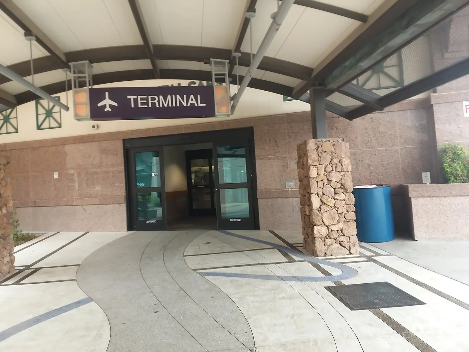 El Paso International Airport terminal identification sign beside the roadway.