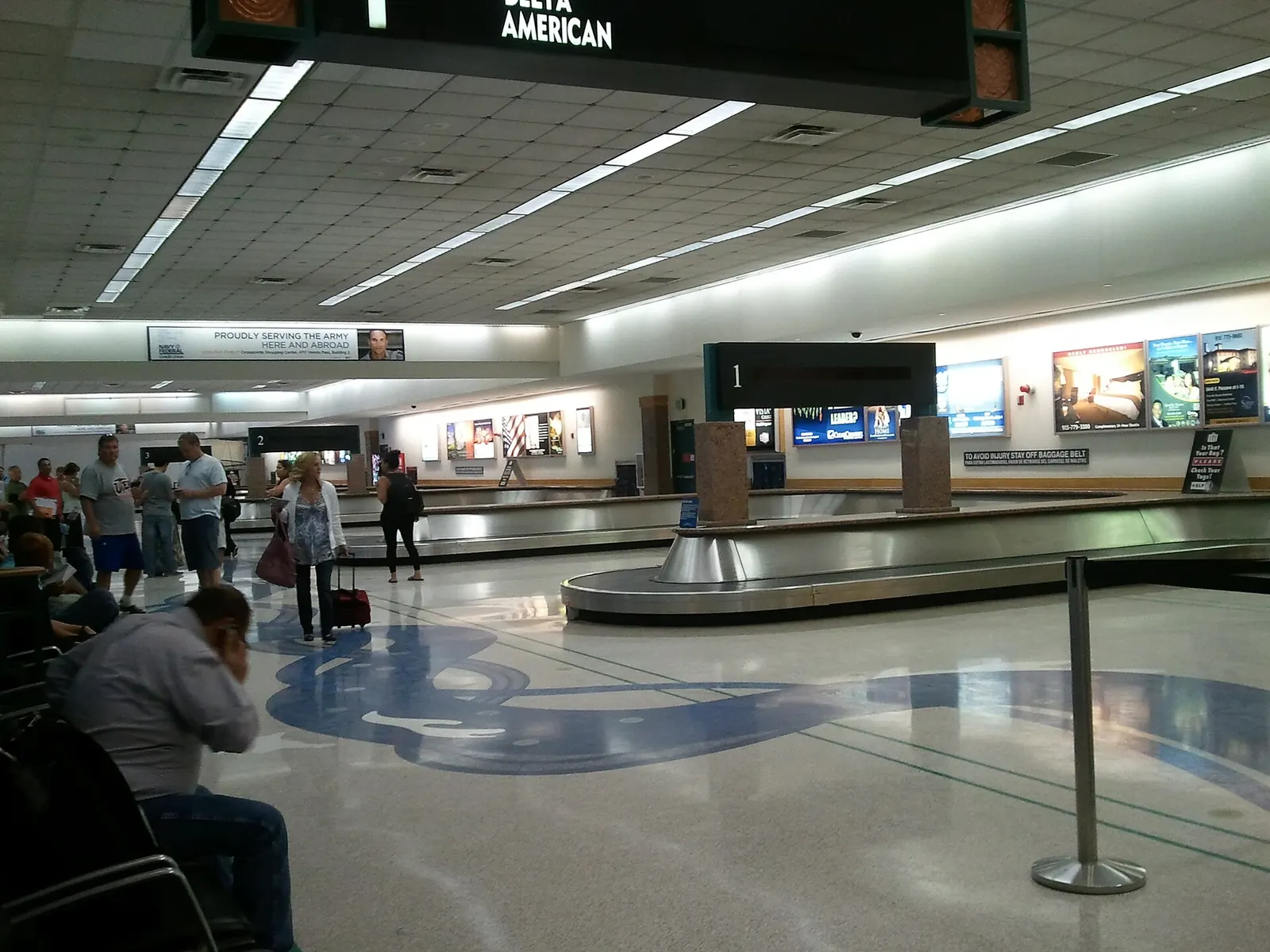Lower-level baggage claim hall at El Paso International Airport with carousels and overhead signs.