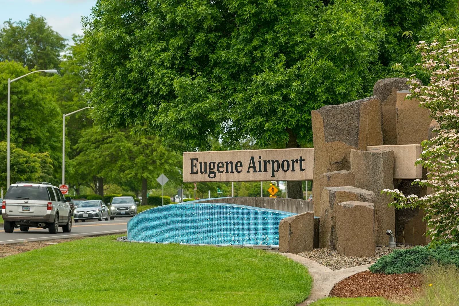 Roadside Eugene Airport monument sign photographed in June 2022.