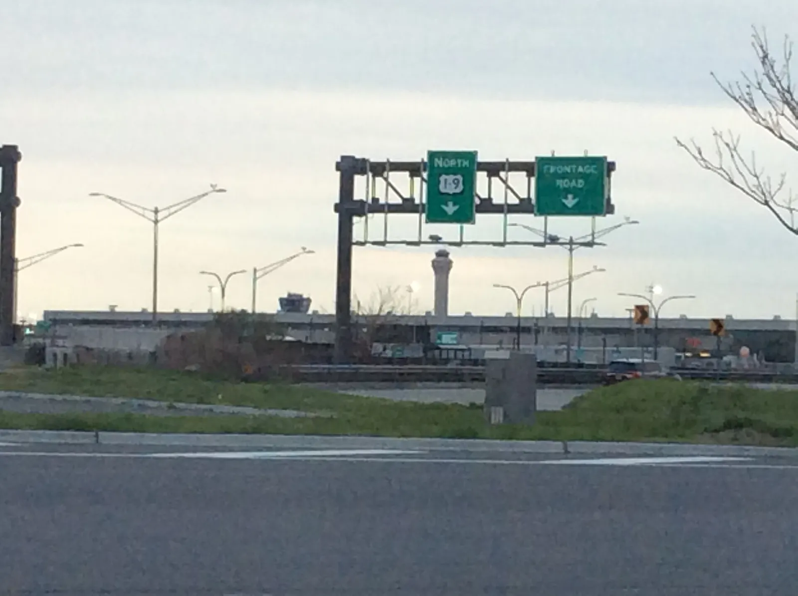 Newark Airport's distinctive control tower and terminal roofs seen from the New Jersey Turnpike interchange.