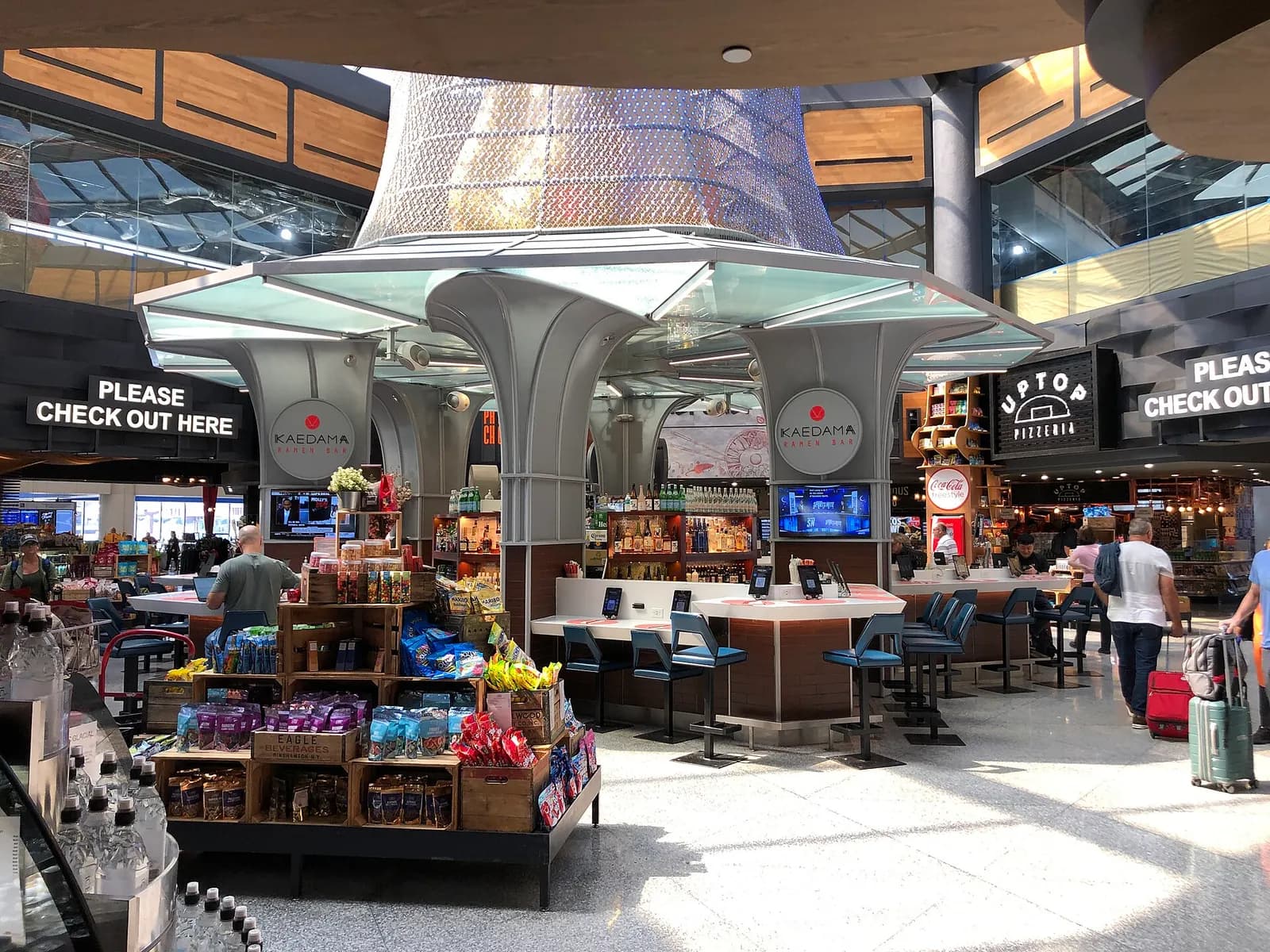 The Global Bazaar food court in Terminal C with multiple restaurant counters and seating under a decorative ceiling.