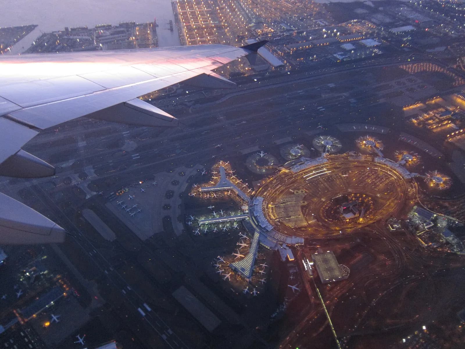 Aerial view of Newark Liberty International Airport's terminal buildings and ramp as seen from a departing airplane.
