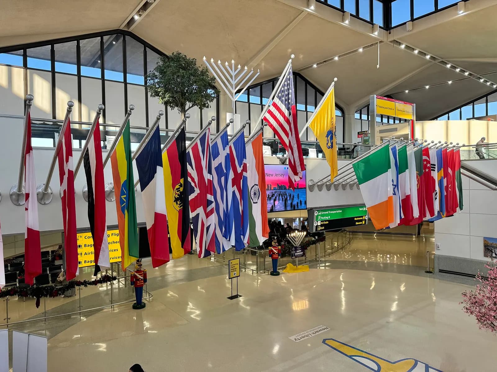 A row of national flags hanging in Terminal B representing countries served by international flights from Newark.