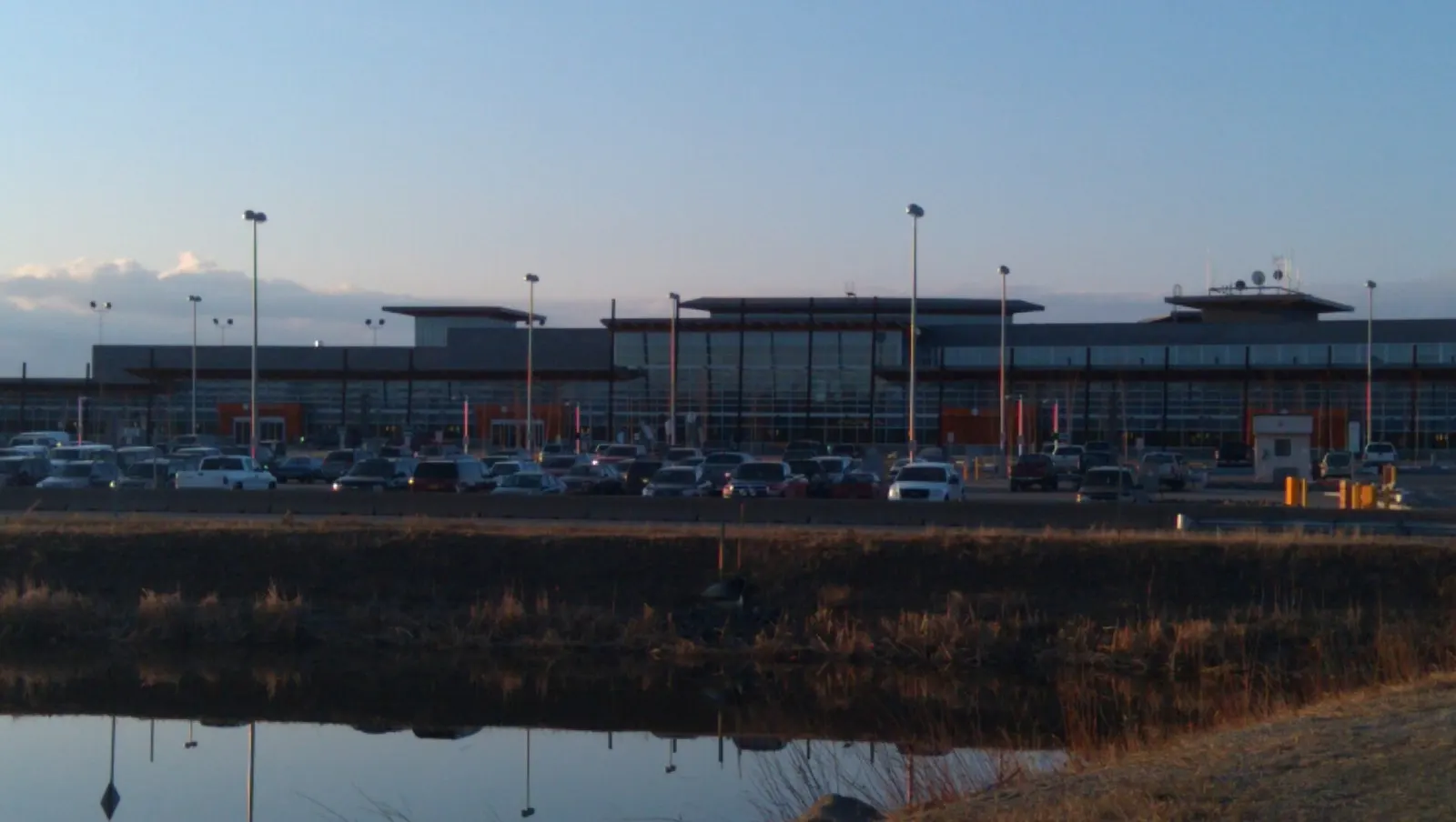 Fairbanks International Airport main terminal with short-term and long-term parking and Wien Lake in the foreground, 9 May 2011