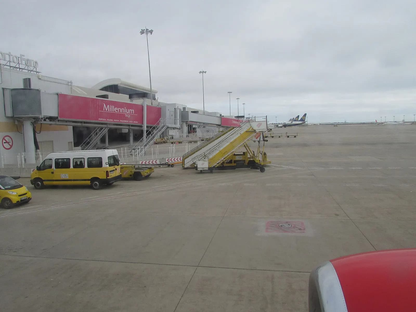 A view of the terminal and boarding gates taken from the window of the Boeing 737 (G-JZHJ) of Jet2 as it is about to depart from Faro airport in the city of Faro , Algarve, Portugal.