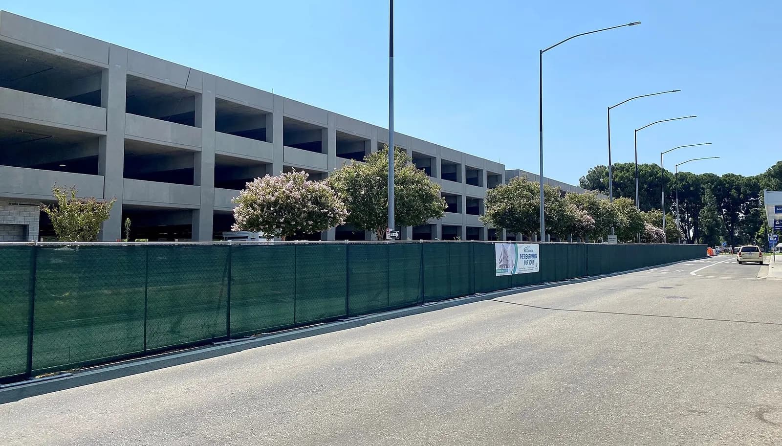 Four-level parking garage under construction in front of the FAT terminal.