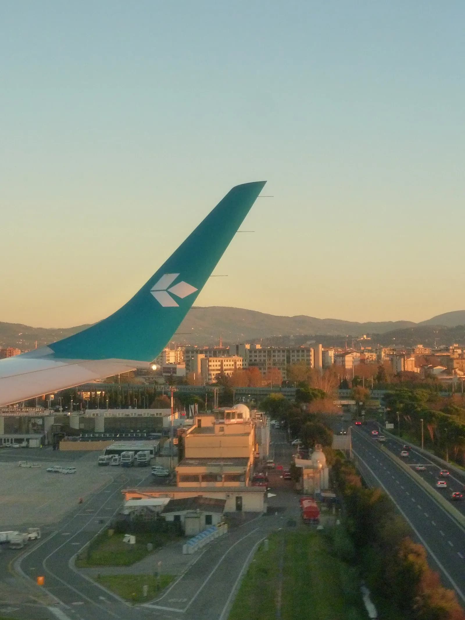 Aircraft landing at Florence Airport with terminal context