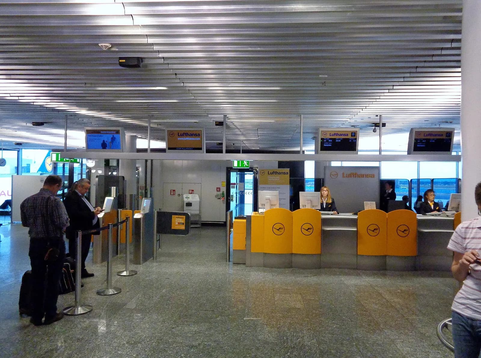 Gate A21 at Frankfurt Airport showing the gate number sign, seating area, and large windows looking out onto the apron.