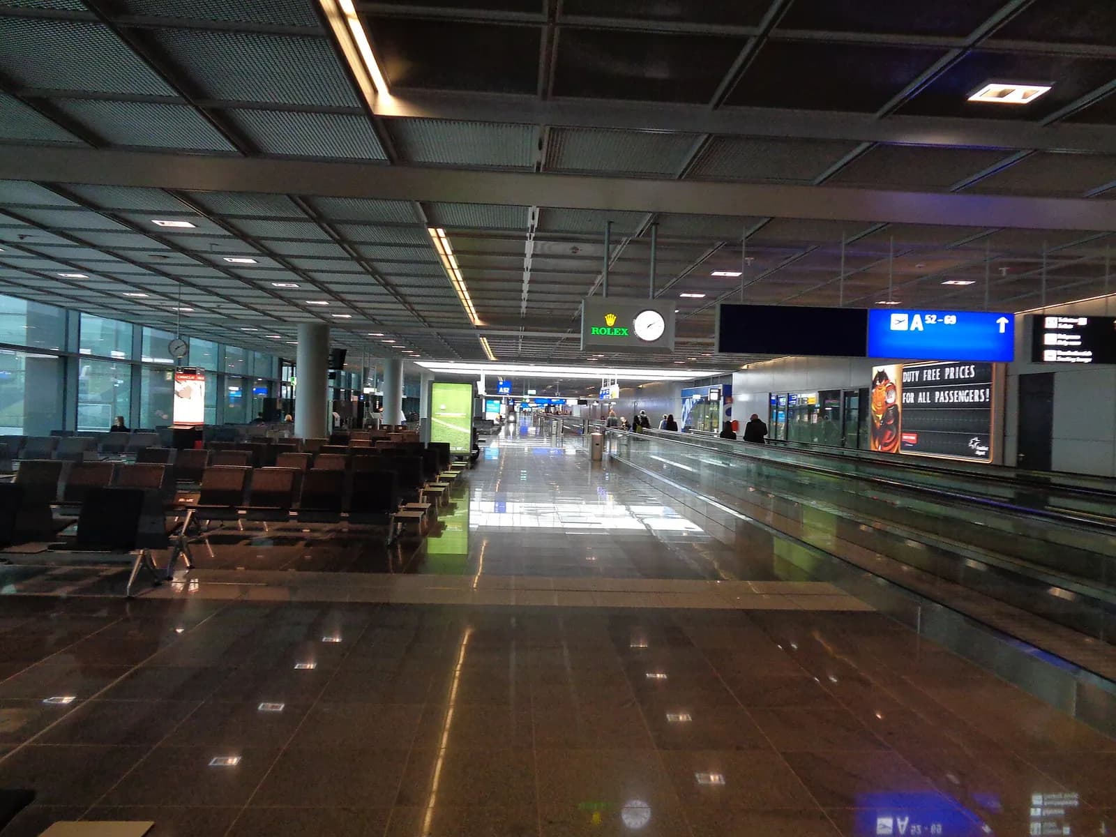 The bright Schengen-level concourse of Terminal 1 Pier A-Plus with gate seating areas, walkways, and Lufthansa branding along the pier.
