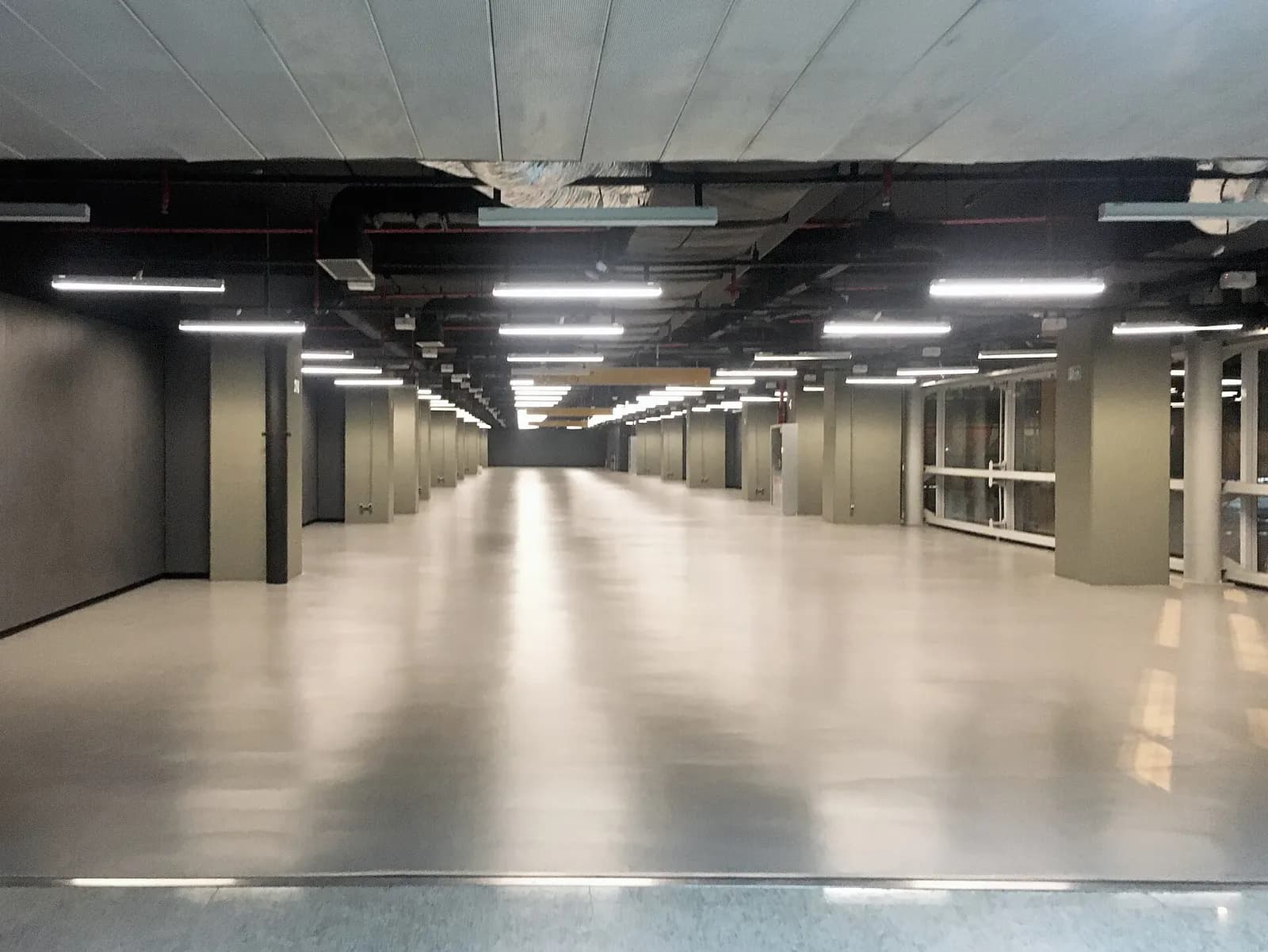 Spacious Galeão terminal interior with high ceilings, departure boards, and passengers moving through the main hall.