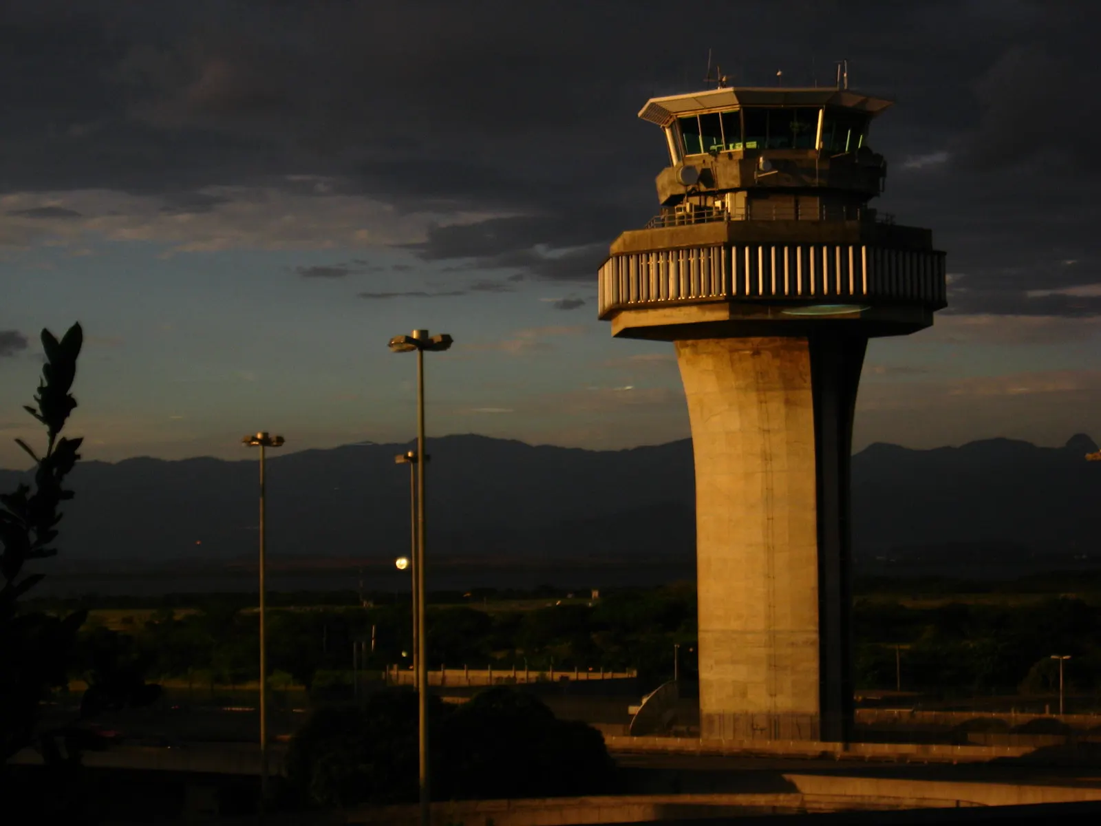 Galeão's airport control tower rising above the surrounding buildings against a clear sky.