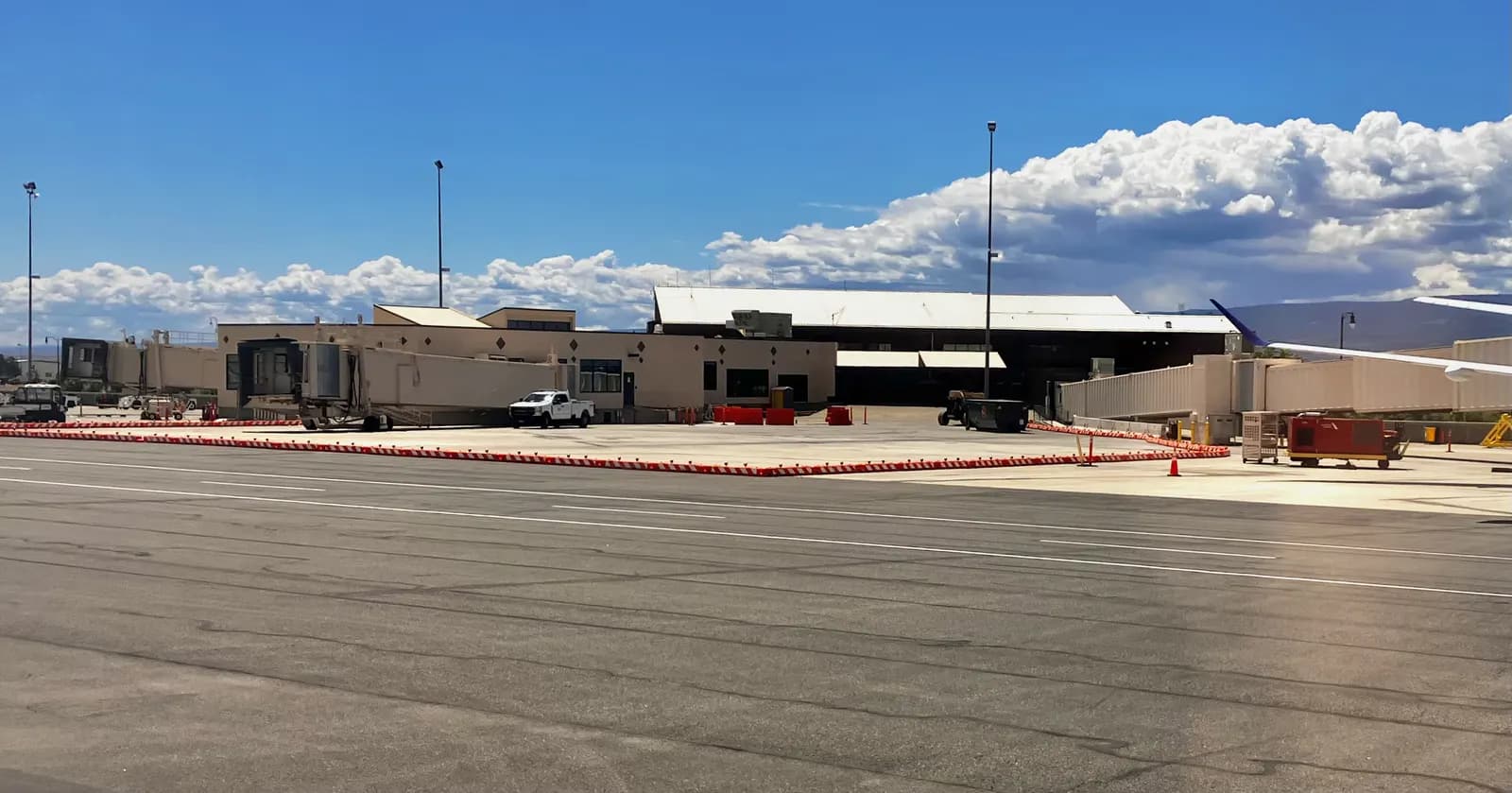 Landside front of the Grand Junction Regional Airport passenger terminal under a blue sky, May 2025.