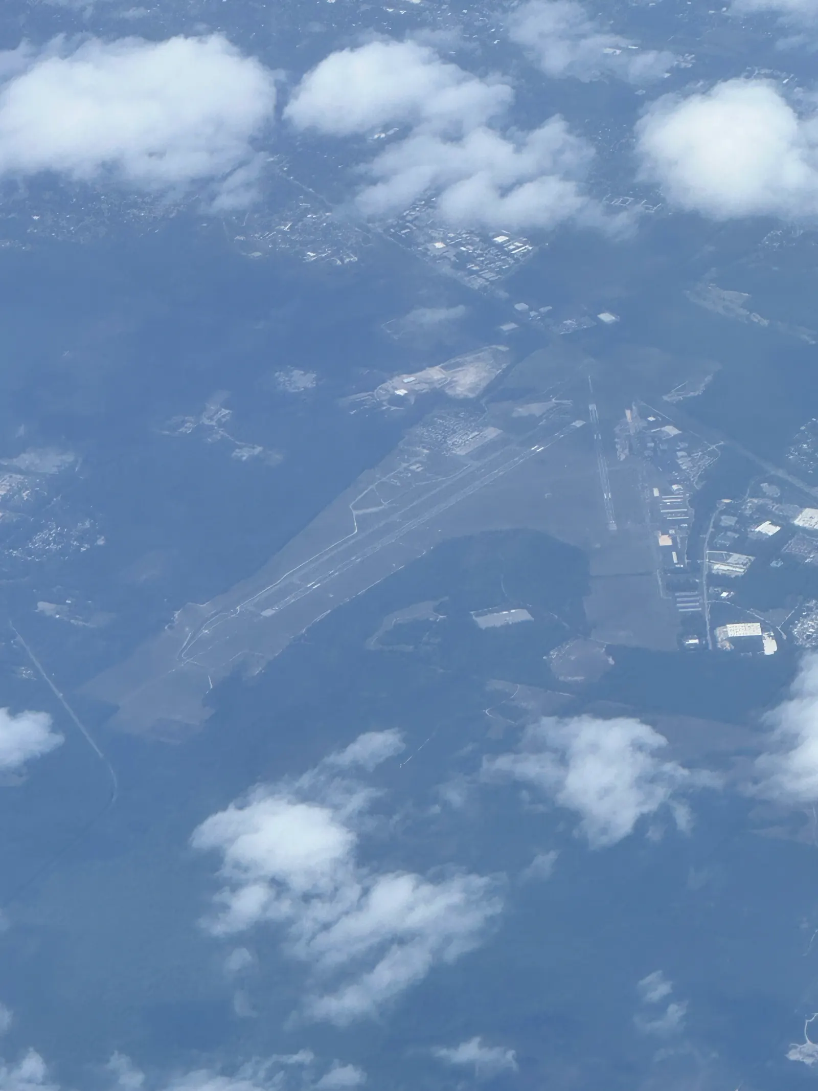 Gainesville Regional Airport seen from a departing commercial flight in 2024, with the passenger hall and airfield below.