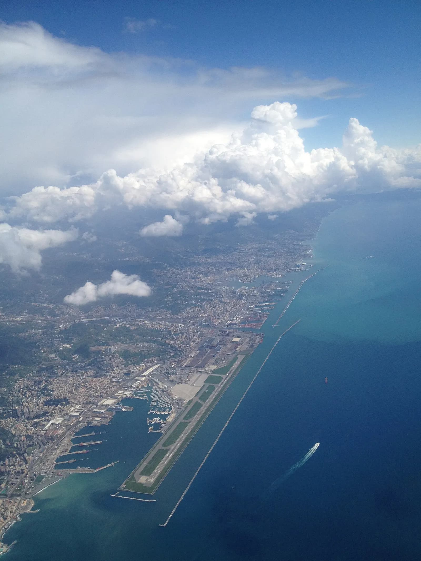 Aerial view of Genoa Cristoforo Colombo Airport on its artificial peninsula between Sestri Ponente and the Ligurian Sea