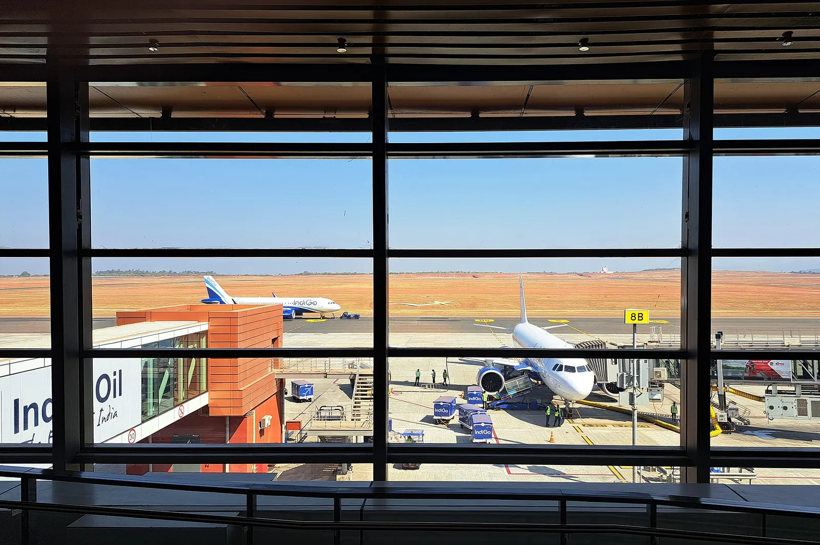 IndiGo aircraft on the apron at Manohar International Airport (GOX), viewed from the terminal