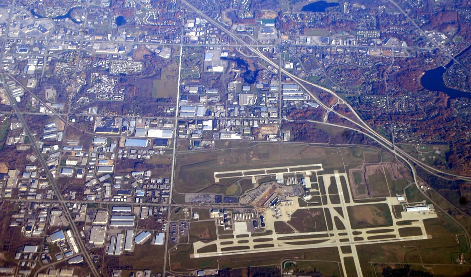 Aerial photograph of Gerald R. Ford International Airport showing the passenger terminal, parking, and crossing runways.