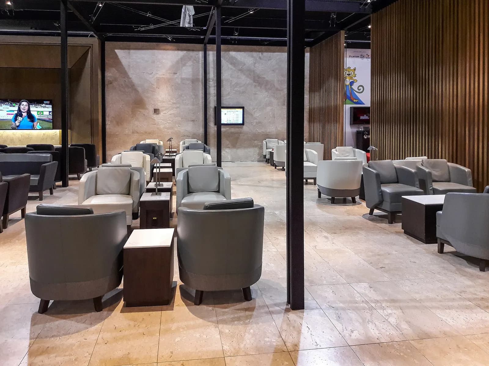 Interior of the LATAM VIP Lounge at GRU with seating areas and a buffet spread.