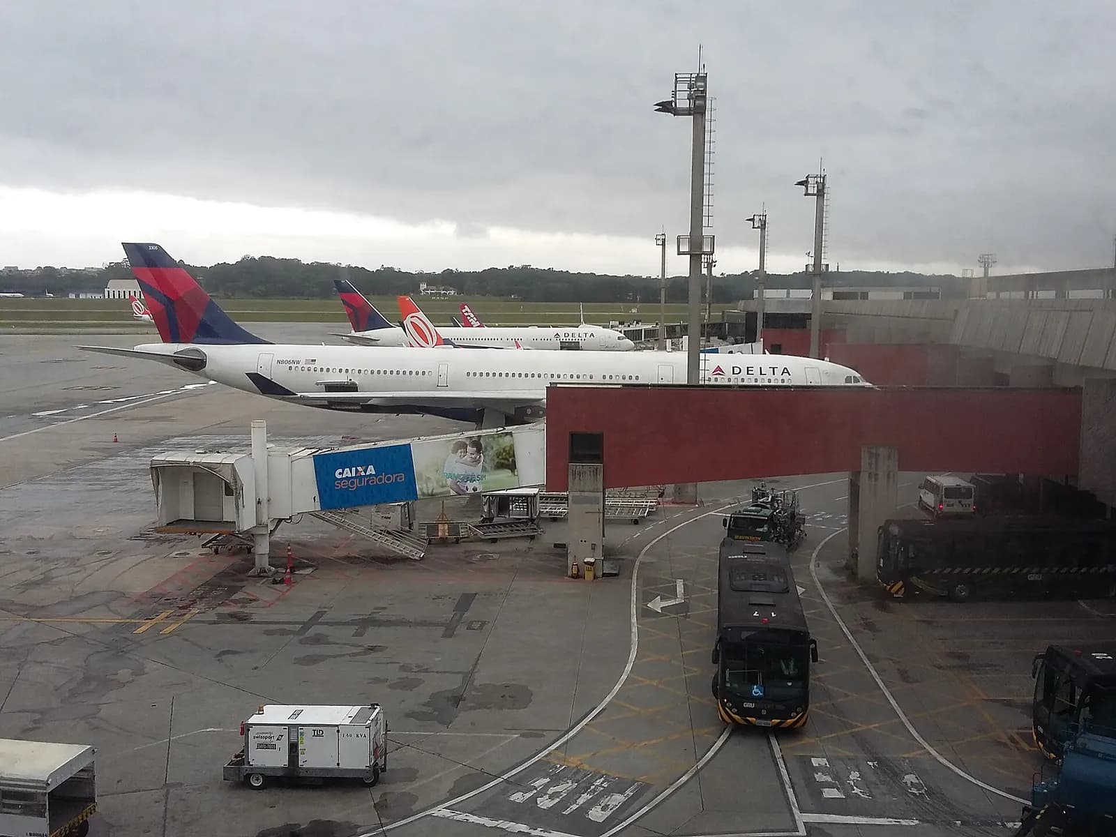 Open-air gate patio at Terminal 2 with aircraft parked on the adjacent apron.