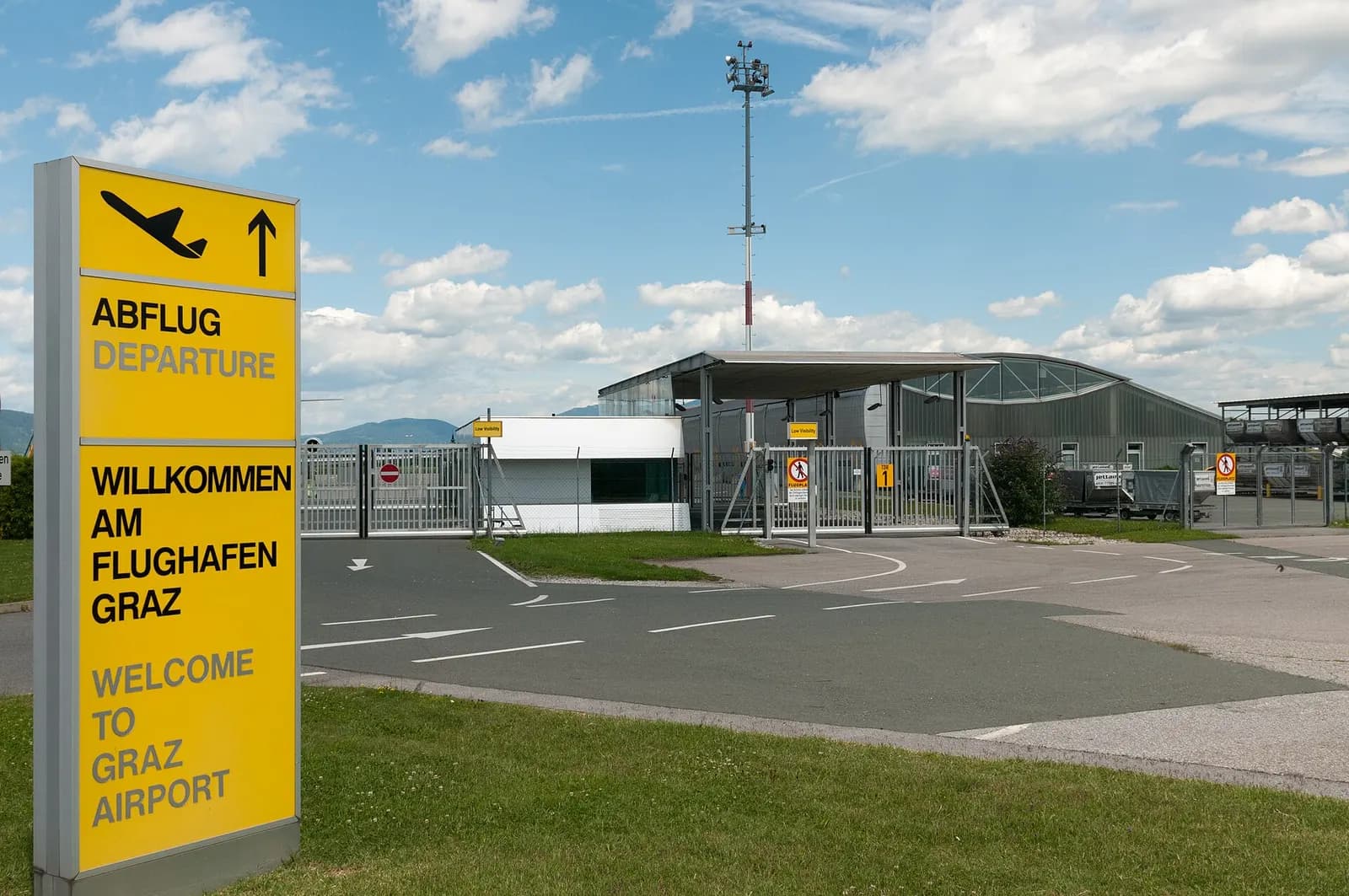 Welcome to Graz Airport roadside sign at the secured airside access road